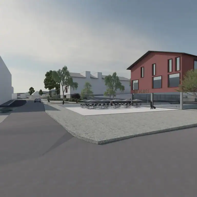 Modern commercial building exterior with outdoor seating area and landscaping, featuring architectural design and urban development.