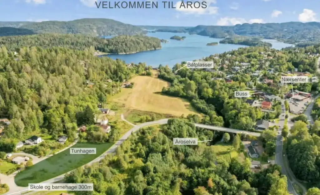 Lush green landscape with lakes and forested hills, showcasing scenic views and outdoor recreational areas.