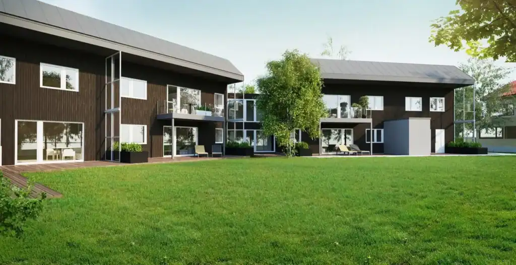 Modern eco-friendly residential buildings with spacious outdoor green area and large windows.
